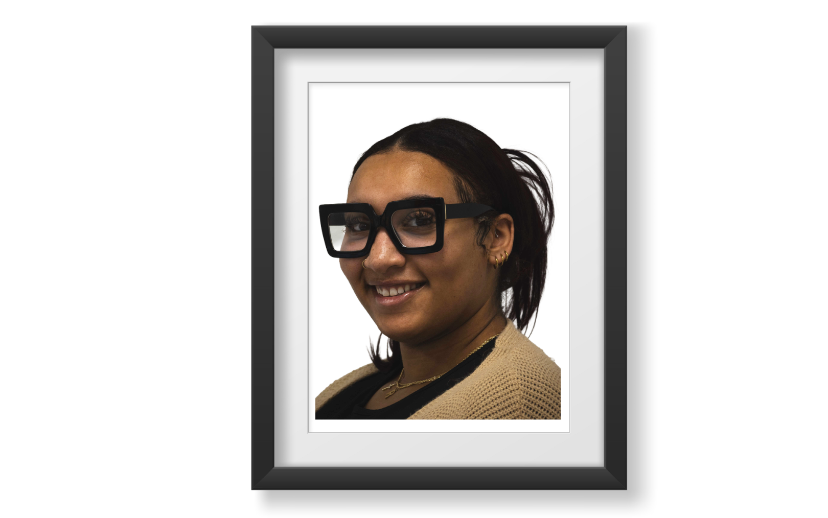 Young professional woman with light complexion accented by natural freckles, with burgundy hair that falls past her shoulders. She also has black-framed glasses with a structured square shape and brown eyes.