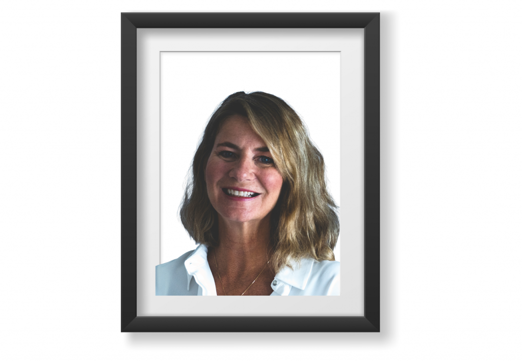 Caucasian middle-aged female with shoulder length wavy sandy brown hair and blue eyes.