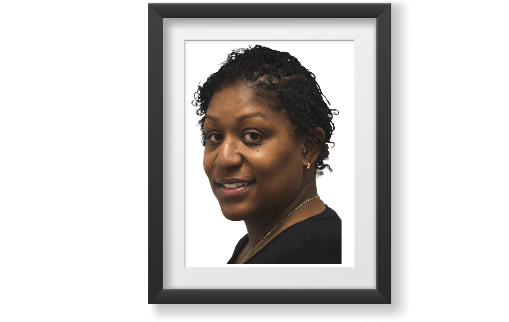 African American Millennial woman. Hair is styled in natural short black locs that stop at her ears. Brown eyes and a medium build. Her smile conveys warmth, confidence, and a relaxed elegance.